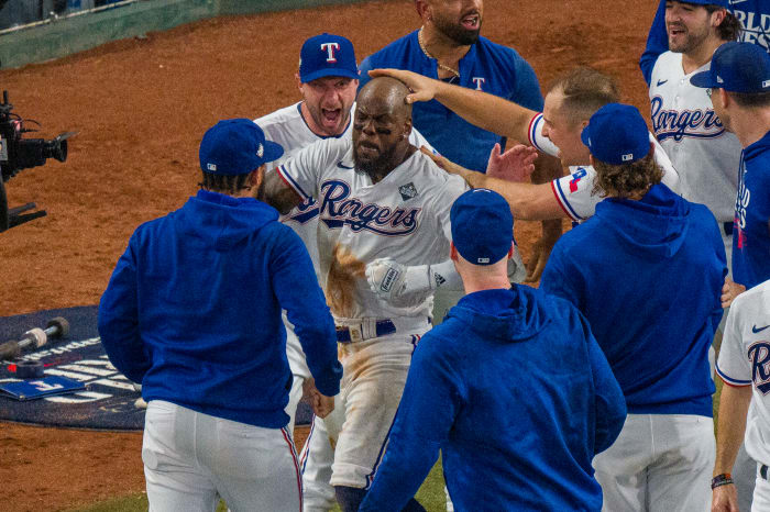 Oct 27, 2023; Arlington, Texas, USA; Texas Rangers starting pitcher Max Scherzer (31) and first baseman Nathaniel Lowe (30) celebrate after right fielder Adolis Garcia (53) hits a walk-off home run to defeat the Arizona Diamondbacks during the eleventh inning in game one of the 2023 World Series at Globe Life Field. Mandatory Credit: Jerome Miron-USA TODAY Sports